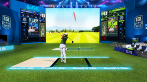 A rendering from behind the back tee box in SoFi Center as a shot heads toward the screen